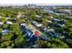 Stunning aerial view of the home with mature landscaping and a picturesque view of the water and skyline at 1017 W Charter St, Tampa, FL 33602