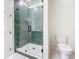 Contemporary bathroom featuring a glass enclosed shower with patterned tile walls and a white toilet at 1017 W Charter St, Tampa, FL 33602