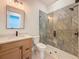 Bathroom featuring a tiled shower, wood vanity, and modern fixtures at 1017 W Charter St, Tampa, FL 33602