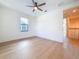 Bright, empty bedroom with hardwood floors, ceiling fan, and natural light from the large window at 1017 W Charter St, Tampa, FL 33602