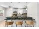 Modern kitchen featuring a breakfast bar with wicker stools, granite countertops, and stainless steel appliances at 11205 Tralee Dr, Riverview, FL 33569