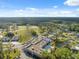 An aerial view of a clubhouse, community pool, a golf course, and a parking area at 11220 Godwit Ct, New Port Richey, FL 34654