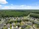 Aerial view of a quiet neighborhood surrounded by lush green forest and a small pond at 11220 Godwit Ct, New Port Richey, FL 34654