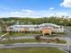 An aerial view showcases clubhouse with manicured landscaping and convenient parking at 11220 Godwit Ct, New Port Richey, FL 34654