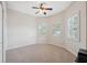 This bedroom features a ceiling fan, neutral walls and a pair of shuttered windows at 11220 Godwit Ct, New Port Richey, FL 34654