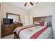 This is a cozy bedroom with wood furnishings, an attractive spread, and a large mirror at 11220 Godwit Ct, New Port Richey, FL 34654