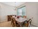 Bright dining room featuring a chandelier and large window, perfect for gatherings and Gathering meals at 11220 Godwit Ct, New Port Richey, FL 34654