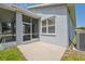View of the screened lanai off the side of the house with grassy area and garden bed at 11220 Godwit Ct, New Port Richey, FL 34654