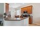 Well-lit kitchen featuring stainless steel appliances and wood cabinetry at 11220 Godwit Ct, New Port Richey, FL 34654