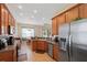 Open kitchen design with stainless steel appliances and breakfast bar seating at 11220 Godwit Ct, New Port Richey, FL 34654