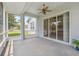 Spacious screened lanai with ceiling fan and sliding glass doors overlooking the backyard at 11220 Godwit Ct, New Port Richey, FL 34654