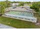 Aerial view of shuffleboard courts surrounded by green grass at 11220 Godwit Ct, New Port Richey, FL 34654
