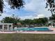 Community pool surrounded by mature trees and lush landscaping offering a refreshing retreat for residents in the neighborhood at 11838 Wildeflower Pl # 11838, Temple Terrace, FL 33617