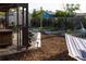 Backyard featuring a hammock, raised garden beds, and mature landscaping at 12021 144Th St, Largo, FL 33774