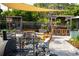Backyard features an outdoor kitchen, dining area, and covered patio at 12021 144Th St, Largo, FL 33774