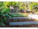 Lush backyard featuring raised garden beds, chicken coop, banana plants and space for outdoor recreation and gardening at 12021 144Th St, Largo, FL 33774