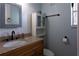 Cozy bathroom with a granite countertop vanity, and a decorative mirror at 12021 144Th St, Largo, FL 33774