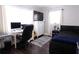 Well-lit bedroom with a desk, dark wood floors, and modern decor at 12021 144Th St, Largo, FL 33774