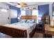 Comfortable bedroom features a wooden bed frame, ceiling fan, and quaint nautical decor at 12021 144Th St, Largo, FL 33774
