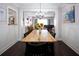Dining room featuring a large wood table, black chairs, and a beautiful view to the living room at 12021 144Th St, Largo, FL 33774
