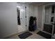 A hallway with tile floors and white wainscoting, leading to other rooms at 12021 144Th St, Largo, FL 33774