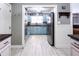 Bright kitchen features light blue cabinets, stainless steel appliances, and light wood-look tile floors at 12021 144Th St, Largo, FL 33774