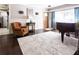 Bright living room featuring hardwood floors, a classic piano, and comfortable seating, creating a welcoming atmosphere at 12021 144Th St, Largo, FL 33774