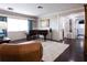 Elegant living room showcases hardwood floors, piano, stylish furnishings, and a sunlit window for a cozy ambiance at 12021 144Th St, Largo, FL 33774