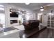 Cozy living room with a fireplace, built-in shelving, dark wood floors, and ceiling fans at 12021 144Th St, Largo, FL 33774