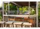Outdoor bar and seating area with a hot tub, and string lights at 12021 144Th St, Largo, FL 33774