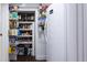 Pantry with an abundance of shelving in this kitchen with an adjacent refrigerator at 12021 144Th St, Largo, FL 33774