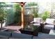 Outdoor seating area beneath a pergola, surrounded by lush greenery, perfect for relaxation and entertainment at 12021 144Th St, Largo, FL 33774
