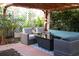 Cozy outdoor patio under a pergola, featuring stylish seating arrangements and lush tropical greenery at 12021 144Th St, Largo, FL 33774