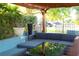 Inviting outdoor patio with comfortable seating under a pergola, perfect for entertaining or relaxing outdoors at 12021 144Th St, Largo, FL 33774