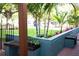 Covered porch, adorned with vibrant plants, offers a relaxing outdoor transition from the tropical garden at 12021 144Th St, Largo, FL 33774