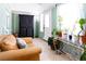 Bright and cozy sunroom with plants and a seating area at 12021 144Th St, Largo, FL 33774