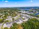 Beautiful aerial view of a condo community with mature trees and a swimming pool near a lake at 1250 S Pinellas Ave # 405, Tarpon Springs, FL 34689