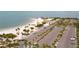 Elevated angle of a tranquil beach featuring palm trees, crystal-clear waters and plentiful parking at 1250 S Pinellas Ave # 405, Tarpon Springs, FL 34689