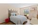 Cozy bedroom with patterned headboard, wood floors, and a brightly lit window at 1250 S Pinellas Ave # 405, Tarpon Springs, FL 34689