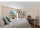 Bedroom with a view to the outdoors, white furniture, and a walk out porch at 1250 S Pinellas Ave # 405, Tarpon Springs, FL 34689