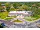Aerial view of a well-maintained clubhouse surrounded by lush landscaping and a circular driveway, creating a community hub at 1250 S Pinellas Ave # 405, Tarpon Springs, FL 34689
