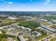 Aerial perspective highlighting the residential buildings and community amenities near green spaces and roadways at 1250 S Pinellas Ave # 405, Tarpon Springs, FL 34689