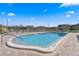 Large community pool surrounded by a patio with lounge chairs and well-kept landscaping at 1250 S Pinellas Ave # 405, Tarpon Springs, FL 34689