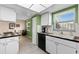 Well-lit kitchen with modern appliances, checkered countertops, and a view of the dining area at 1250 S Pinellas Ave # 405, Tarpon Springs, FL 34689