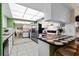 Modern kitchen with white cabinets, checkered countertops, and a view of the dining and living areas at 1250 S Pinellas Ave # 405, Tarpon Springs, FL 34689