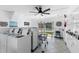 Bright laundry room with multiple washers and dryers, offering convenience for residents, featuring a ceiling fan at 1250 S Pinellas Ave # 405, Tarpon Springs, FL 34689