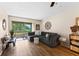 Comfortable living room with balcony access and natural light, neutral paint, and wood-look flooring at 1250 S Pinellas Ave # 405, Tarpon Springs, FL 34689