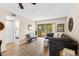 Living room featuring wood-look floors, neutral paint, and sliding glass door to a screened in patio at 1250 S Pinellas Ave # 405, Tarpon Springs, FL 34689