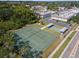 Aerial view featuring tennis and shuffleboard courts, providing ample recreational options for community residents at 1250 S Pinellas Ave # 405, Tarpon Springs, FL 34689