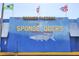 Charming Sponge Docks sign featuring a detailed mural of a fish and flags from different nations at 1250 S Pinellas Ave # 405, Tarpon Springs, FL 34689